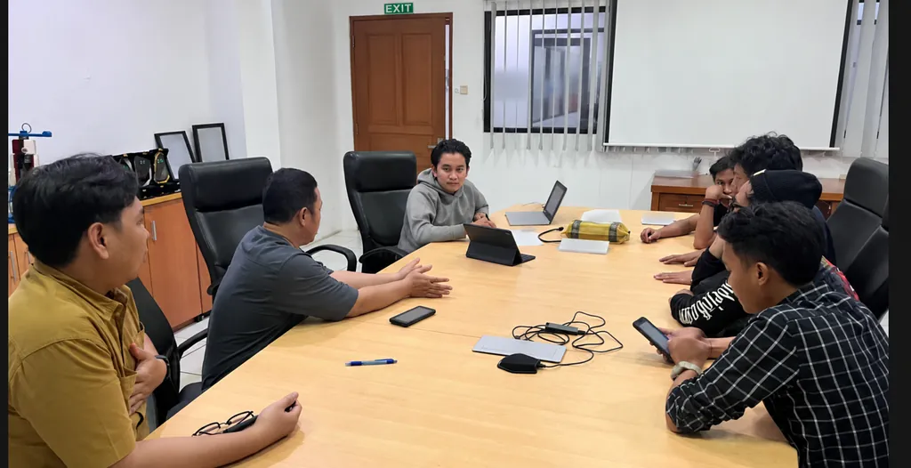 Project team in a meeting room reviewing project progress together.
